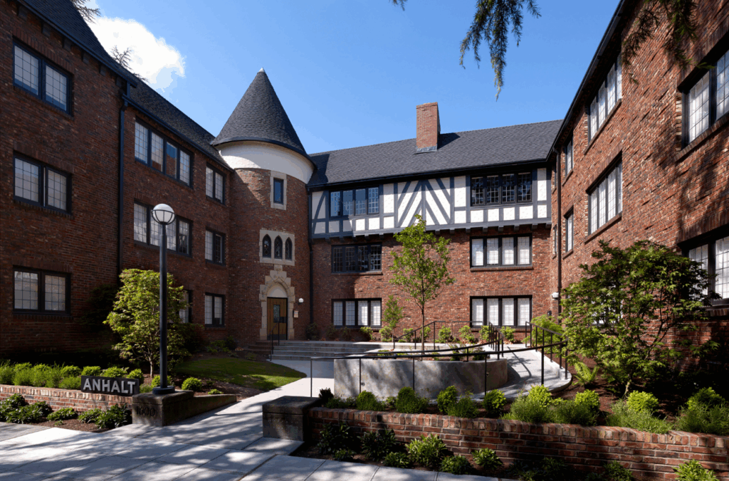 Anhalt Apartments courtyard with historic Tudor architecture and lush landscaping in Seattle multifamily real estate asset