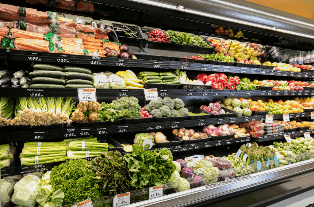 Fully stocked fresh produce section inside grocery store highlighting tenant stability for family office retail investment