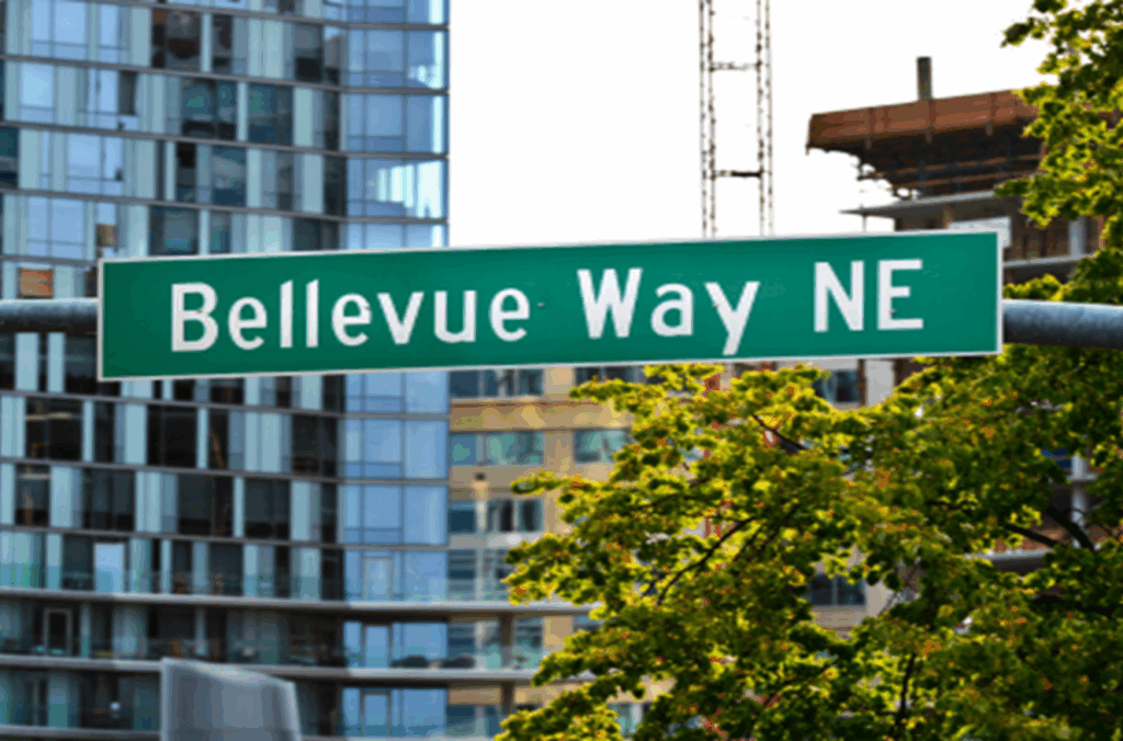 Bellevue Way NE street sign with modern high-rise buildings in the background, highlighting urban redevelopment in downtown Bellevue