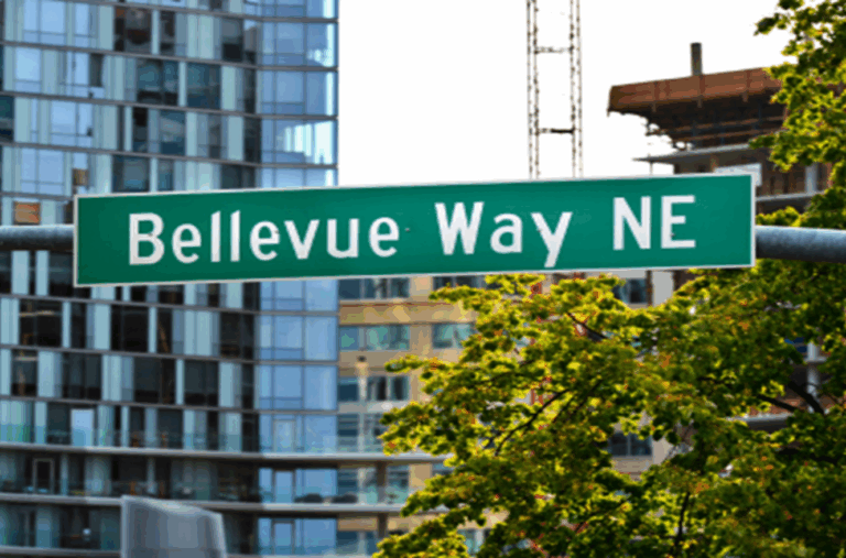 Bellevue Way NE street sign with modern high-rise buildings in the background, highlighting urban redevelopment in downtown Bellevue