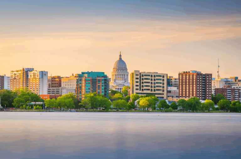 Skyline of Madison, Wisconsin with State Capitol building at sunset, representing family office real estate investment in urban core